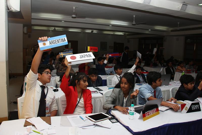 Students engaged in a Model United Nations (MUN) simulation, discussing global issues and practicing diplomacy